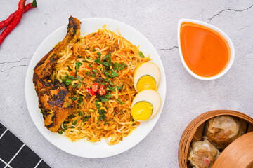 curry laksa with rice noodles, egg and chicken. Laksa is a type of noodle dish with spices typical of Peranakan culture that combines Chinese and Malay. Asian traditional soup.	
