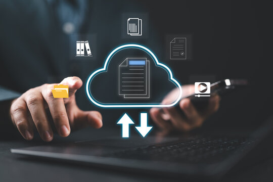 Businessman using laptop and dashboard for data management with computer showcasing a cloud-based documentation system for efficient digital file storage,online documentation technology