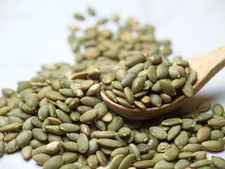  Close up of a pile of pumpkin seeds.