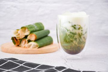glass of cendol ice, Cendol is an iced sweet dessert that contains droplets of green rice flour jelly, coconut milk and palm sugar syrup. It is commonly found in Indonesia