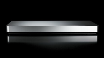 Silver rectangle device on dark reflective surface.  Possible use Product display