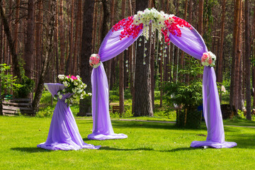 original beautiful wedding arch in a pine forest for marriage registration