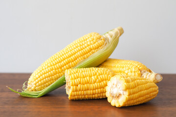 Fresh corn on wooden table background