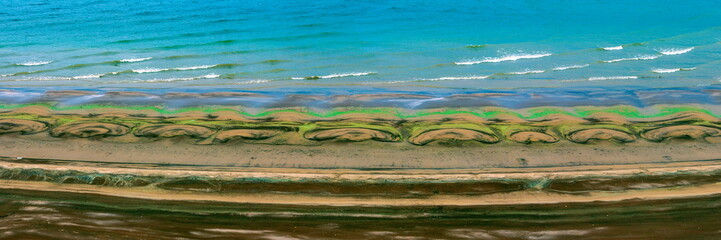 Sandy wild beach of the Volga river on an autumn day