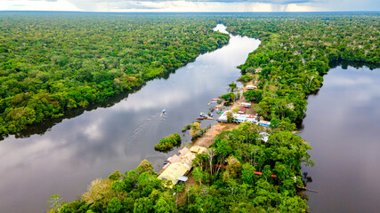 Aerial View of the Amazon Rainforest with River and Local Settlement in Colombia