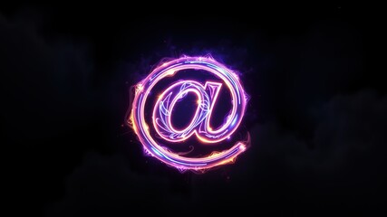 A three-dimensional, transparent "@" symbol with a glossy, rainbow-colored sheen. A dark, black background.