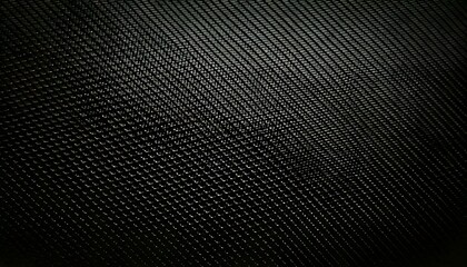 Futuristic black carbon fiber texture with fine detailed weave pattern in ultra-HD.
