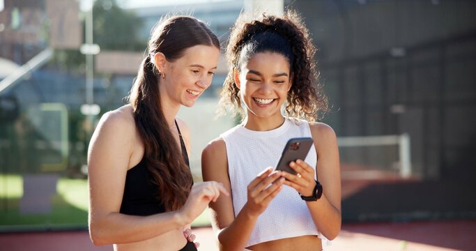 Sports, online and women with phone on tennis court for social media post, internet joke or chat. Fitness club, happy and friends on smartphone after training, exercise and workout for match practice