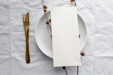 A minimal 5x7 inch blank menu paper placed on a ceramic plate, styled for elegant wedding table...