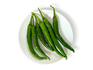 Fresh Green Chili Peppers in a white plate isolated on white background with clipping path and copy space. Top view Flat lay. Perfect for design element, spicy food concept or any commercial usages.