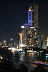 Obraz premium View of Bangkok, Thailand at night, showing the Chao Phraya River and boats. Taken on 22 Dec 2023.