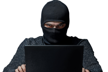 Cybercriminal in Black Mask Using Laptop Isolated on Transparent Background – Concept of Hacking, Cybersecurity, and Online Fraud  

