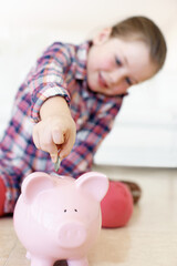 Home, child and money in piggy bank for saving, financial responsibility and investment with...