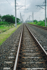 Obraz premium Railway tracks crossing green rice fields, Klaten, Central Java, Indonesia