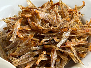 fried small fish on white dish