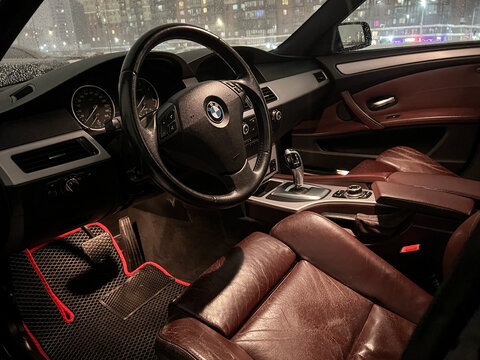 BMW E615-series individual steering wheel, dashboard, gear shifting. Red leather car interior. Vehicle interior car. The modern interior of a premium car. 