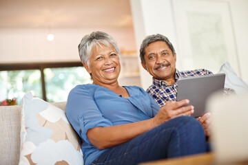 Mature couple, tablet and portrait on sofa for love, support and romance bonding in living room together in home. Senior man, happy woman and smile on couch with online entertainment or video