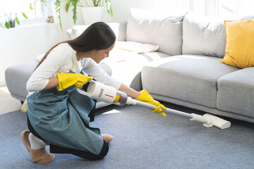 Vacuuming cleaning, housekeeping asian young woman, girl cleanup with portable cordless vacuum...
