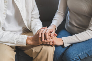 Anxiety depress, grief asian young couple comfort discuss concern hold hand encourage and support,...