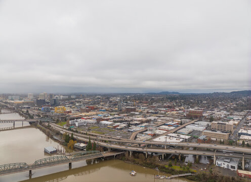 A city view from above with a bridge and a river in the background