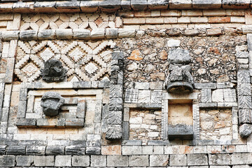 Elaborate lattice and woven mat design mosaic stone work on the buildings in the Nunnery quadrangle at the Mayan temple complex of Uxmal,Near Merida,Yucatan,Mexico