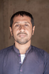 Obraz premium Portrait of a Pakistani Man in Traditional Dress | Rural Background | Confident Expression | Natural Lighting