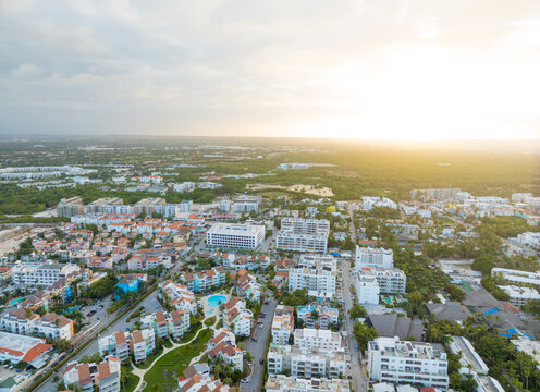 A city view with a lot of white buildings and a few green trees