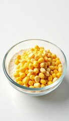 Clear glass bowl filled with flour and corn kernels on white background, kitchen, ingredients, texture