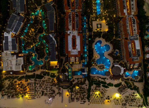 A beach with a hotel complex in the background