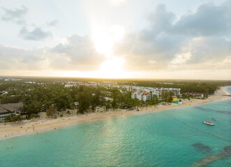 A beautiful beach with a clear blue ocean and a bright sun in the sky