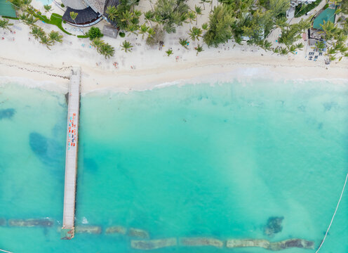 A beautiful blue ocean with a pier in the foreground