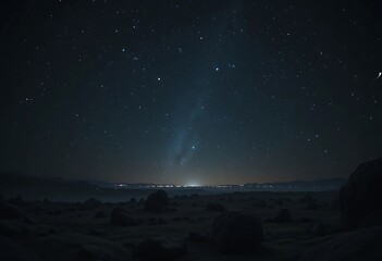 Majestic starry night sky over rocky landscape with distant lights