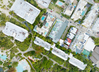 A city view of a residential area with a large white building in the middle