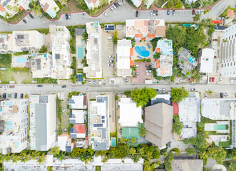 A city street view with a mix of residential and commercial buildings