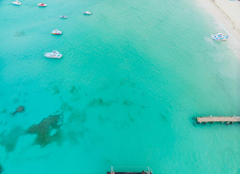 A beautiful blue ocean with a pier in the foreground