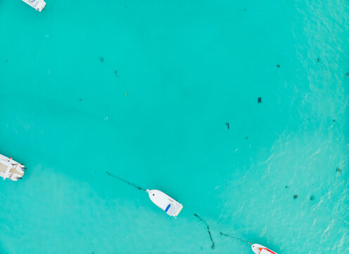 A blue ocean with a boat in the middle