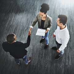 Business people, shaking hands and contract at office, above and documents for deal, team or respect at startup. Woman, men and b2b partnership for collaboration, onboarding or diversity at company
