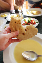 Egyptian flatbread Aish Baladi served with Tahini soup in a Luxor restaurant, Egypt
