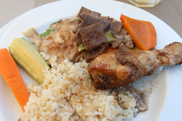 Egyptian rice with baked chicken drumstick, beef, carrot and cucumber in a Hurghada resort, Egypt