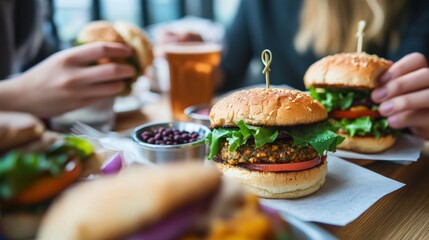 School cafeteria with students eating veggie burgers. Featuring veggie patties, lettuce, tomato, and pickles