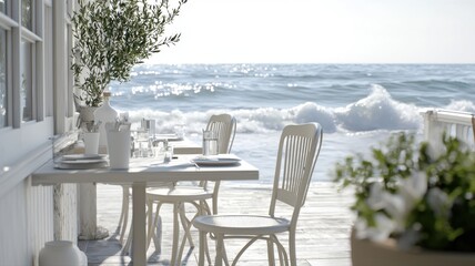 Fototapeta premium Seaside dining setting with tables on a sunny deck overlooking crashing ocean waves and framed by lush greenery.