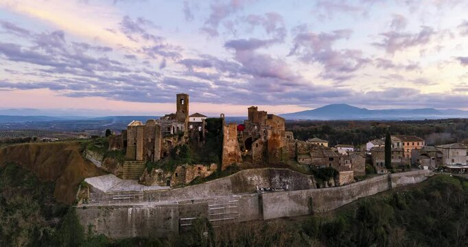 Aerial hyperlapse video of the ancient ruins in Celleno, Italy. The footage captures stunning panoramic views of historical architecture and scenic landscapes with dramatic skies in the background
