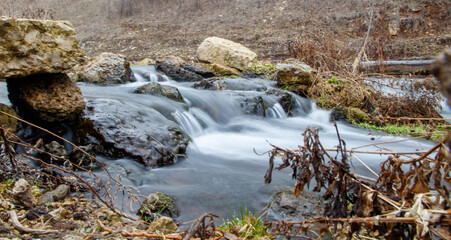 A stream of water flows between rocks