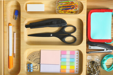 organized top drawer of the desk with stationaries