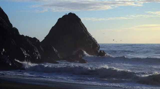 Usal Beach Campground California seagulls birds huge surf waves crashing untouched rugged coastline rocky bluffs Chimney column pillar stacks spire structures black sand golden sunset clear skies