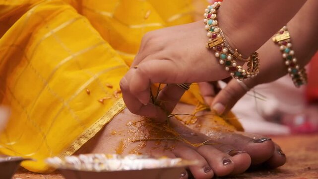 Closeup of bride feet during haldi ceremony in an Indian wedding
