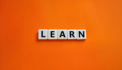 A vibrant orange background with the word 'LEARN' in bold blocks.