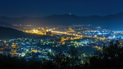 Obraz premium Night city lights panoramic view, mountain backdrop, travel, tourism
