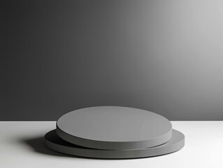 Minimalistic gray platforms on a smooth surface against a simple gray backdrop.
