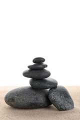 Stack of zen stones on the sand isolated on white background.